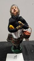 Signed Baboushka Caroler figurine by Byers Choice, front view showing details of dress and basket.