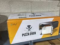 Boxed Deco Chef electric pizza oven showing brand and product type.
