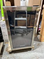 Front view of the Honeywell mini fridge can cooler showing the reflective tinted glass door with stainless steel frame.