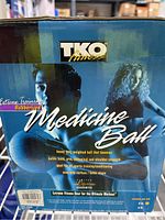 Photo of original packaging showing TKO Fitness brand and features of the medicine ball.