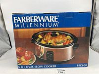 Box front showing Farberware Millennium 6 Qt Oval Slow Cooker FSC600 image with food inside and brand name.