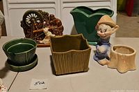 Grouping of six ceramic planters including three McCoy and others with various shapes and colors