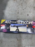 Top view of original product box showing Tasco 402 Power Telescope image and branding.