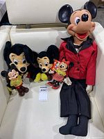 Full view of all five dolls, including large ventriloquist Mickey, two plush Mickeys, and two small hard plastic Mickey and Minnie dolls.