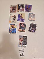 Photo showing 10 basketball trading cards laid flat on a white surface.