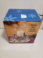Photo of the Christmas Village Hurricane Candleholder box showing product image and description.