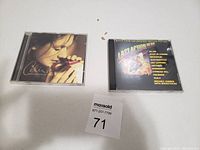 Two jewel case CDs: Celine Dion's "The Colour of My Love" and "Last Action Hero" soundtrack.