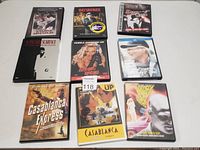 Eight classic movie DVDs arranged in two rows showing various titles such as Scarface, Casablanca, and others.