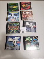 Photo showing eight dance music CDs with various compilation titles in jewel cases.