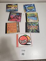 Seven dance music CDs spread out on a surface with original jewel cases and cover art.