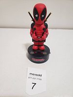 Front view of Deadpool bobblehead clock showing character figure and clock base