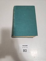 Front cover of vintage green cloth hardcover book Gone with the Wind, showing minor wear.