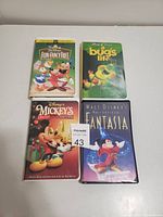 Photo showing four kids VHS tapes in good condition arranged on flat surface.