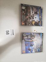 Top view of two PlayStation 3 game cases: MotorStorm and 3D Ultra MiniGolf Adventures, showing front cover art.