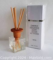Omnibus fragrance diffuser bottle with wooden cap and reeds, alongside box labeled Ocean No.105464.