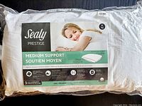 Front photo of pillow packaging showing brand, model, support level, and a sleeping woman illustration.