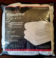 Front packaging showing Beautyrest Black branding and luxury down alternative duvet description with cotton material and hypoallergenic fill.