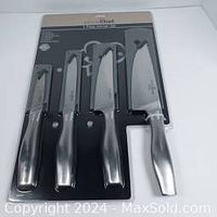 Sealed package of Prime Chef brand 4-piece cutting tool set with various kitchen knives with black handles and blade covers.