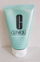 Front view of the light green tube showing Clinique logo, product name, and key details.