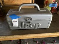 Closed portable Jeep branded CD player in gray plastic case with handle and large Jeep embossed logo on front.