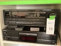 Front view of Pioneer SX-201 stereo receiver and Sony CDP-X202ES CD player stacked on a shelf showing brand logos and controls.