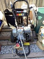 Full front-facing photo of Honda GC160 pressure washer showing engine, pump, wand, and wheels.