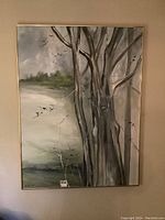 Framed painting depicting birch trees with branches and a misty background, soft natural colors
