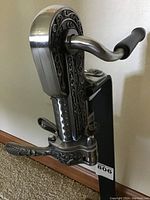 Side view showing detailed pewter engraving and metal crank handle