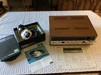 Overall view of receiver, headphones, manuals and box on table