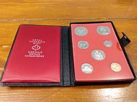 Full view of the red and black Royal Canadian Mint presentation case containing eight Canadian coins dated 1971, displayed clearly in the tray with red backing.