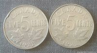 Reverse side of two 1922 Canadian five cent coins with denomination and maple leaf design, showing wear consistent with circulated coins.