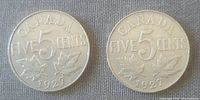 Reverse side showing denomination 'FIVE 5 CENTS' and maple leaves on two 1927 Canadian five-cent coins.