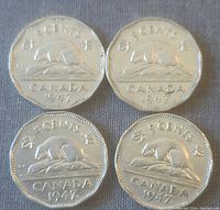 Four 1947 Canadian 5 cent coins reverse side showing beaver and denomination, arranged in two rows.