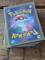 Stack of Japanese Pokémon cards showing the card backs with the Pokémon logo and Poké Ball design.