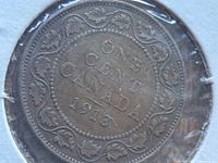 Reverse side of the coin showing denomination and date with decorative maple leaf border.