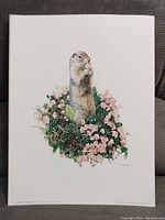 Print depicting a realistic prairie dog standing upright among green foliage and pink flowers.