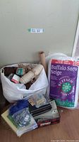 Overall view of craft items including yarn skeins, jute roll, stuffing bag, sewing sundries, and buttons.