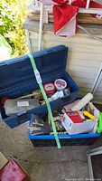 Photo of two open toolboxes containing various hardware, paint supplies, and Jobmate sander box with painting accessories visible