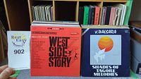 Front view of vinyl records with visible album covers West Side Story and Shades of Tagore Melodies.