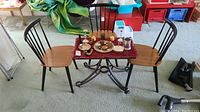 Wide view of table and chairs with decorative items on top