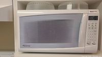 White Panasonic Inverter microwave oven model NN-S615WFX with front door and buttons visible