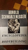 Front cover of the book showing title, author, and image of Arnold Schwarzenegger flexing his bicep.