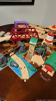 Lot of Brio and Thomas train wooden track pieces with bridge and figures including lighthouse and hippos