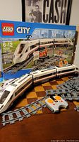 LEGO City 60051 train set box with train, tracks and remote on table