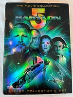 Front cover of Babylon 5 The Movie Collection 5-Disc Collector's Set DVD case showing main characters and a starship in space.