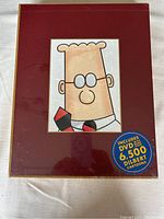 Front view of the new, unopened Dilbert 2.0 box set with cartoon character portrait and DVD sticker.