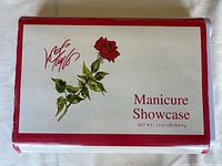 Closed white manicure case with red border and rose graphic, labeled 'Manicure Showcase'