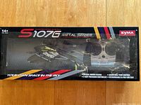 Full retail box for SYMA S107G Metal Series remote controlled helicopter showing helicopter and controller inside clear plastic window.