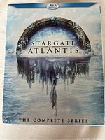 Front cover of the Stargate Atlantis Blu-ray complete series box set showing the Stargate logo and artwork.