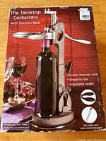 Box of the tabletop corkscrew showing product image and features like suction base, adjustable height, foil cutter, and extra worm included.